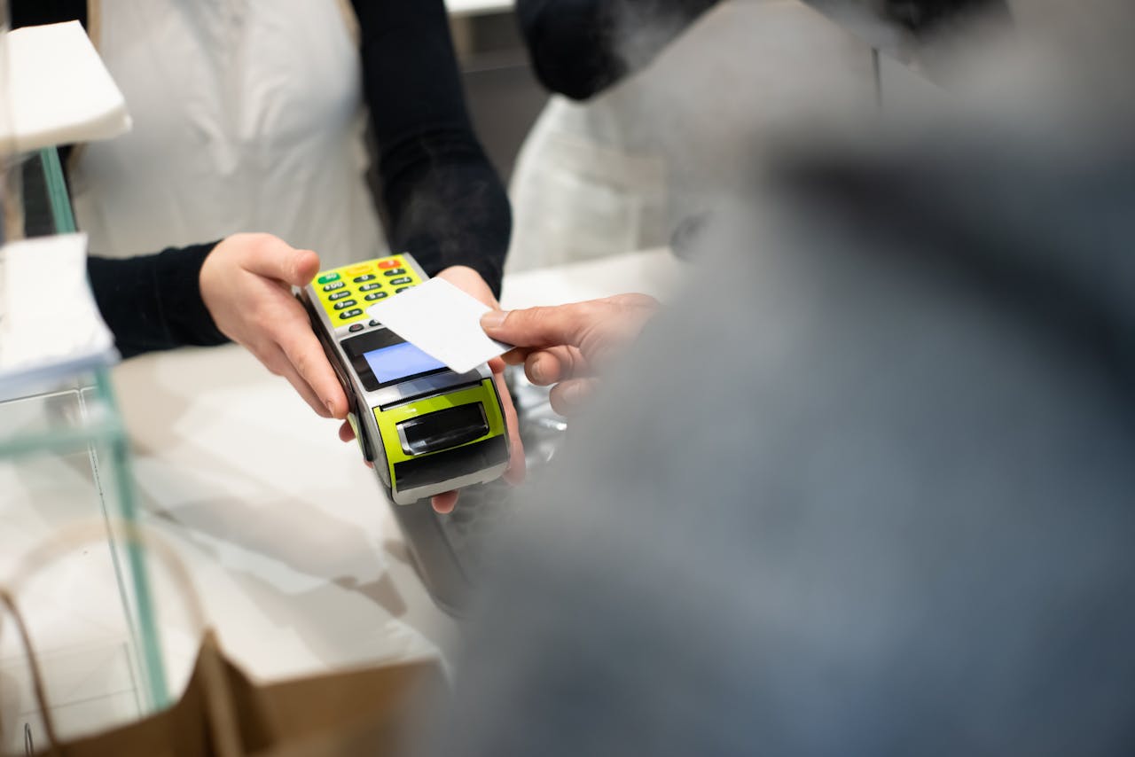 Customer completing a card payment at a retail terminal